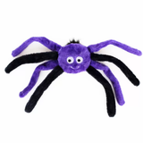A purple and black plush spider toy with large white eyes and a small stitched smile, photographed on a plain white background.
