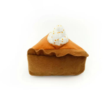 Plush toy resembling a pumpkin pie with whipped cream on a white background