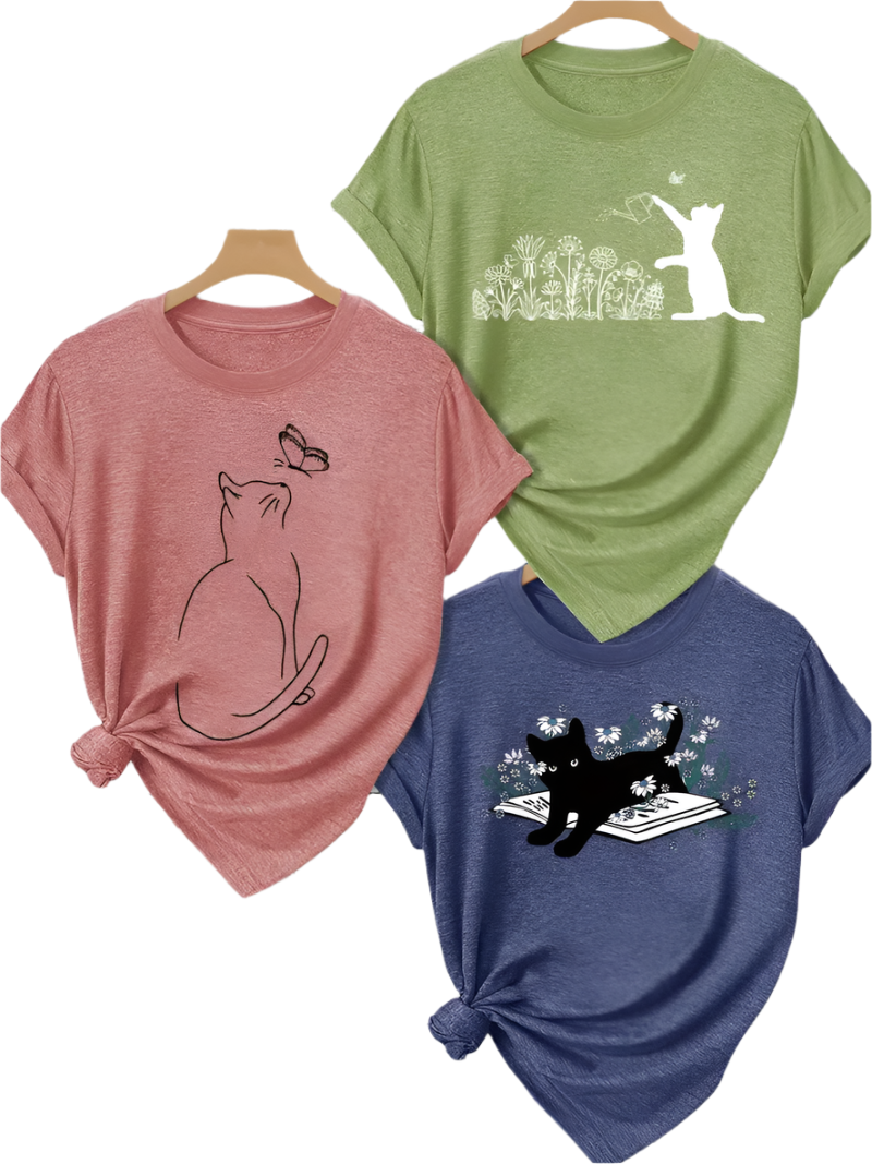 Three t-shirts with cat designs on a white background