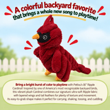 A plush red cardinal toy with layered wings and orange feet is centered on a soft outdoor-style background with a white picket fence and greenery. Large promotional text at the top reads, 'A colorful backyard favorite that brings a whole new song to playtime!' and a text box at the bottom describes the toy and its playful uses.