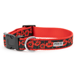 A red and black dog collar with a black and red poppy pattern, featuring a black plastic buckle, a silver metal ring, and a white brand label that reads 'WORTHY OF DANG'.
