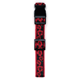 A pet collar with a black plastic buckle and a woven strap featuring a red poppy floral pattern on a black background.