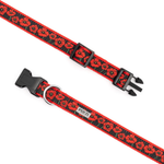 A red and black dog collar with a repeating poppy pattern, featuring black plastic quick-release buckles and a silver metal D-ring, shown on a plain white background.