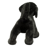 Black plush dog toy on a white background
