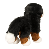 Plush toy dog with black, brown, and white fur on a white background