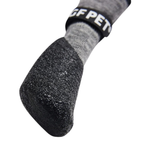 Close-up of a textured black dog boot with a gray knit upper section and a black elastic band featuring white 'CF PET' lettering, set against a plain white background.
