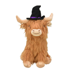 A fluffy Highland cow plush toy with long tan-brown fur, cream-colored face and hooves, and a black witch hat with a purple band, shown against a plain white background.