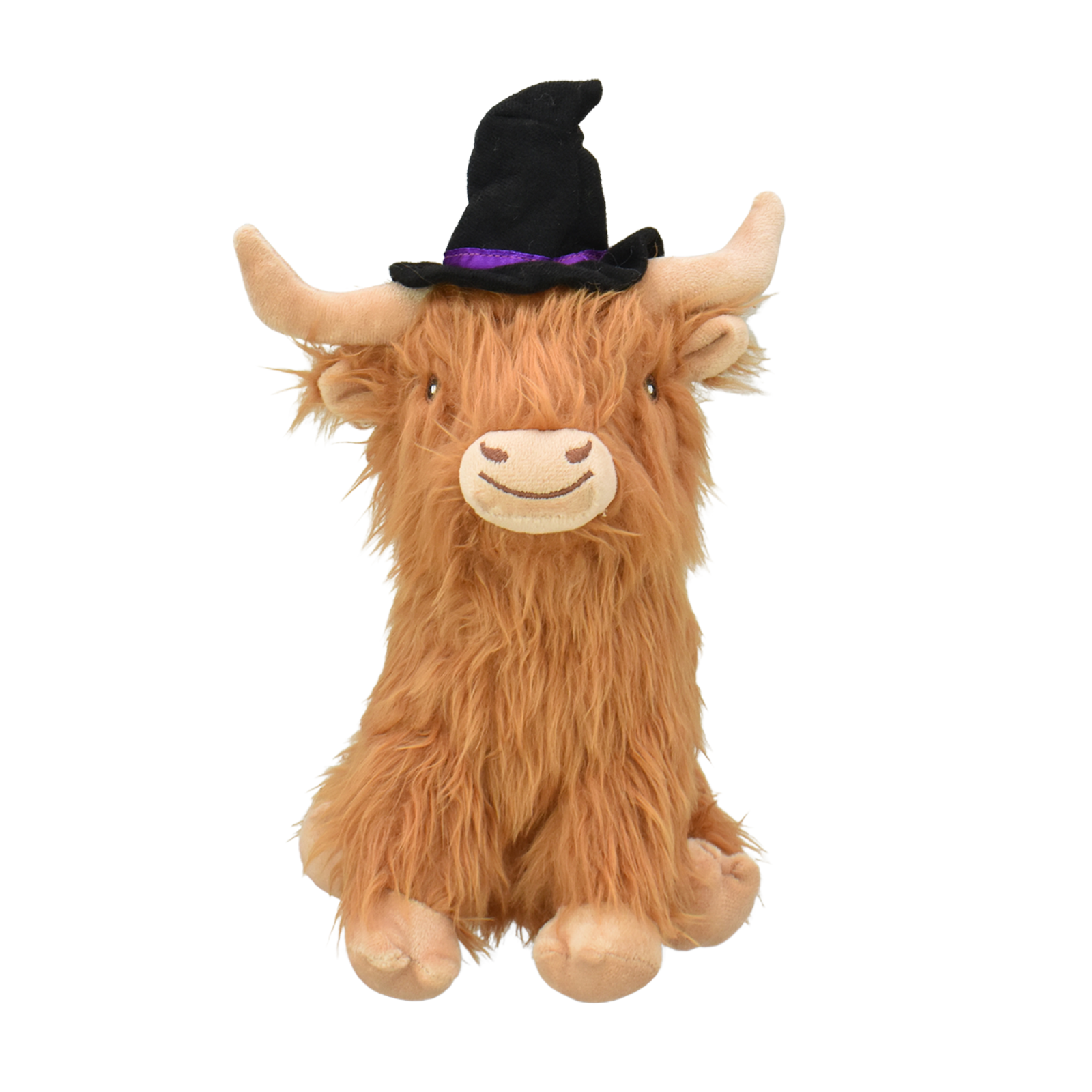 A fluffy Highland cow plush toy with long tan-brown fur, cream-colored face and hooves, and a black witch hat with a purple band, shown against a plain white background.