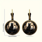 Pair of earrings with black cat design on a white background
