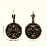 Pair of earrings with cat design on a white background