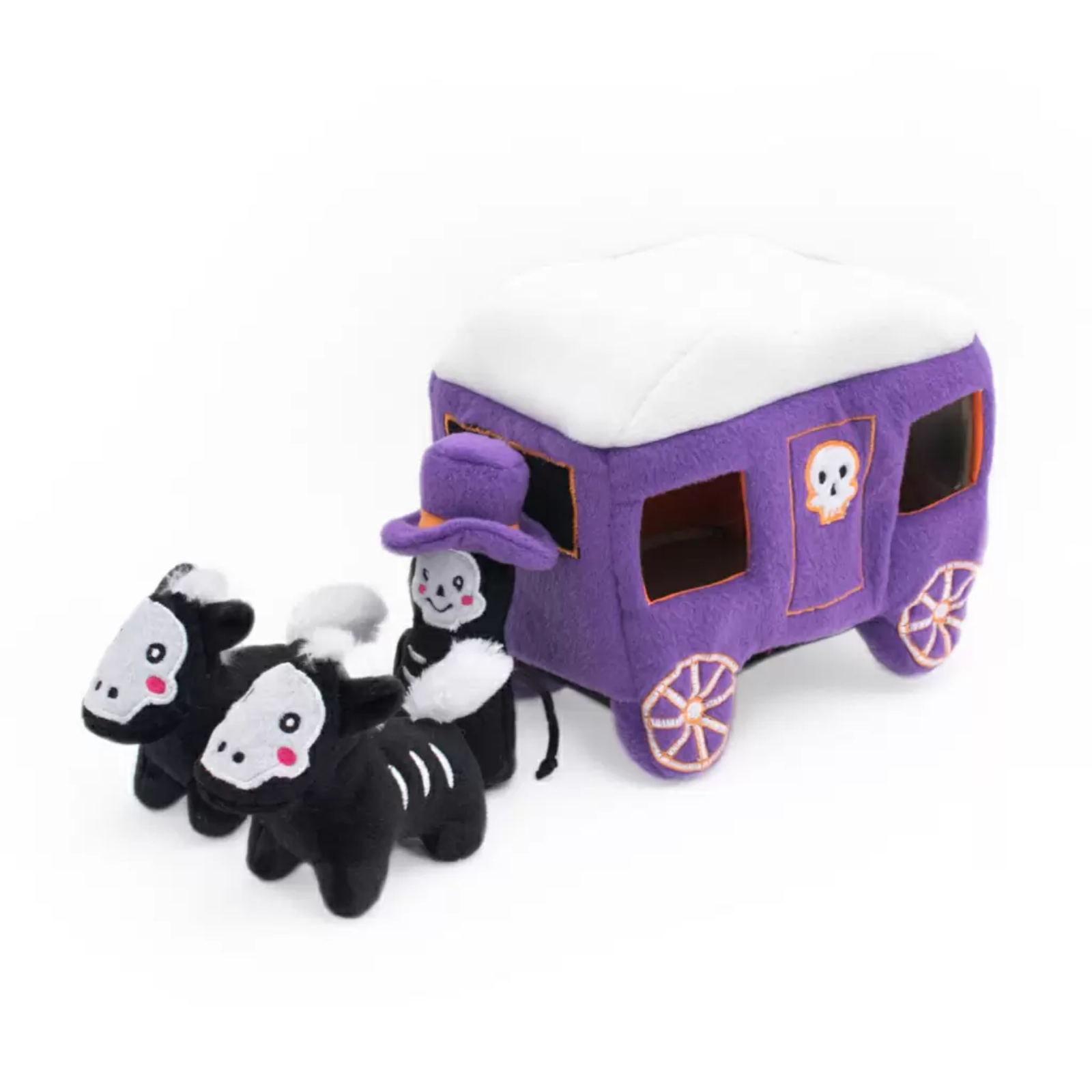 A purple and white Halloween-themed plush dog toy set featuring a covered wagon with a skull emblem and two black-and-white skeleton horses pulled by a skeleton driver, photographed on a white background.
