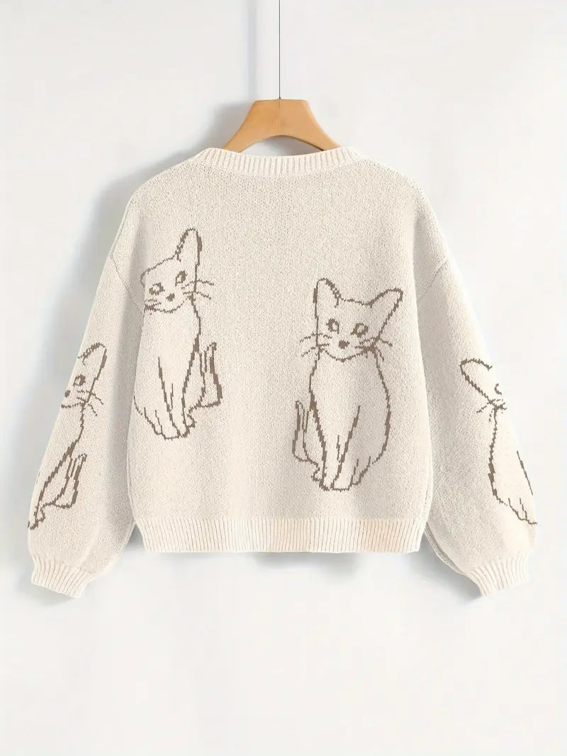 Beige sweater with cat illustrations on a hanger against a white background