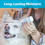 Person holding a bottle of pet product with a dog, labeled for long-lasting moisture and tear stain removal.