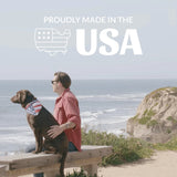 Person with a dog on a wooden bench by the ocean with 'Proudly Made in the USA' text overlay.