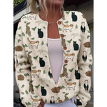 Cardigan with cat pattern worn by a person, with a blurred background