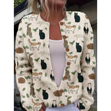 Cardigan with cat pattern worn by a person, with a blurred background