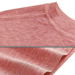 Close-up of a dusty rose pink t-shirt showing the ribbed collar and textured fabric, with a horizontal seam line separating two close-up views of the material.