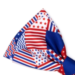 A patriotic patchwork bow tie featuring red, white, and blue stripes, stars, and chevron patterns, shown on a clean white background.