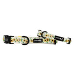 Dog collar with sunflower pattern and 'Sassy Woof' branding on a white background