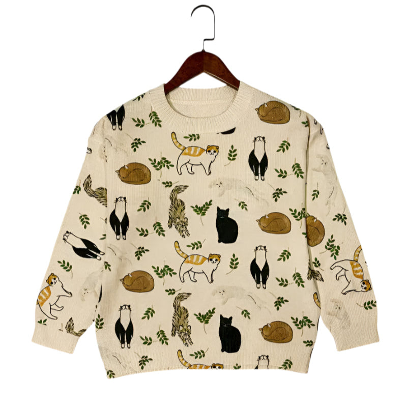 Beige sweater with animal pattern on a hanger against a white background