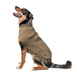 Dog wearing a brown knitted sweater with cross patterns on a white background