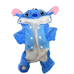 Blue plush toy with a hood on a gray textured background