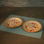 Two decorative plates with autumn leaf patterns on a light blue tray.
