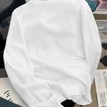 White sweatshirt on a chair with a magazine underneath