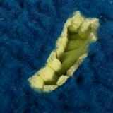 Close-up of blue fleece fabric with a yellow stitching detail