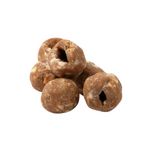 Stack of brown dog treats on a white background