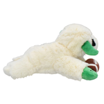 A plush dog toy shaped like a white dog lying down and holding a small brown football, photographed on a plain white background.