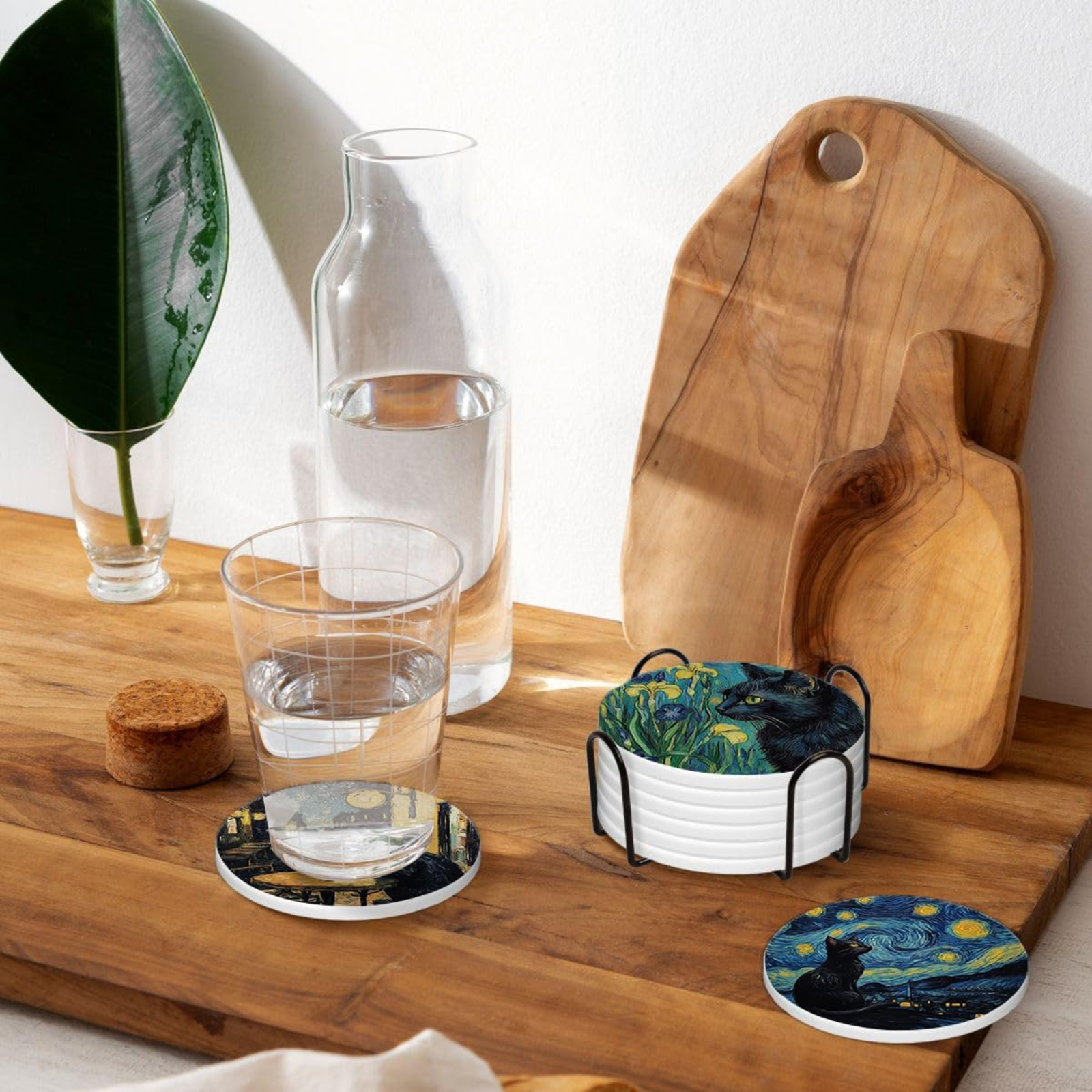 Wooden cutting board with glass coasters featuring famous artworks on a wooden surface.