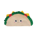 A plush taco-shaped cushion with a cute face, featuring a beige textured center, green ruffled lettuce, yellow cheese, and red tomato details, set against a solid light gray background.