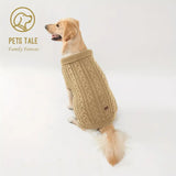Dog wearing a beige knitted sweater on a white background with 'Pets Tale' branding.