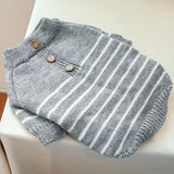 Gray and white striped baby romper with buttons on a white surface