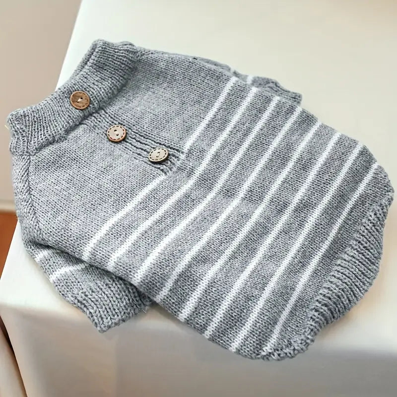 Gray and white striped baby romper with buttons on a white surface