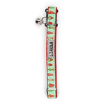 A festive cat collar with a silver bell, featuring a mint green background printed with red and green Christmas trees, red dots, and the text 'WISHING CAT' in black.