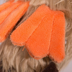 Close-up of orange gloves with textured surface on a blurred background