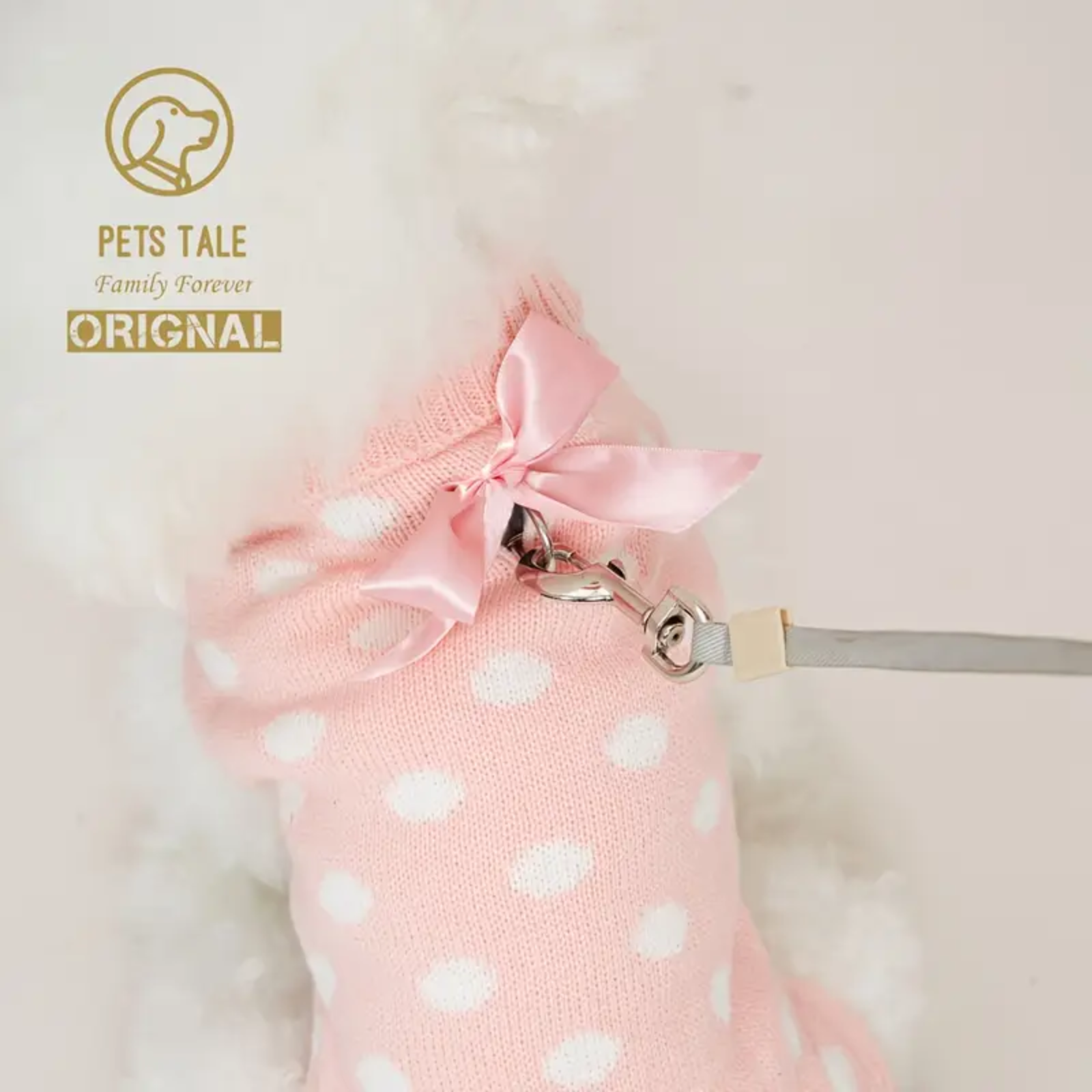 Pink polka dot pet carrier with a bow and leash, branded 'Pets Tale'.