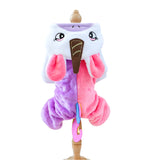 Plush toy resembling a cartoon character with a purple and pink design on a stand.