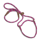 A pink braided rope dog leash with multicolored flecks and brown leather handle grips, shown on a clean white background.