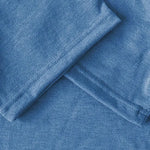 Close-up of blue fabric with a subtle pattern