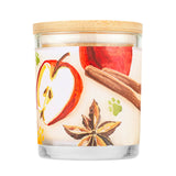 Candle with apple, cinnamon stick, and star anise design on a white background