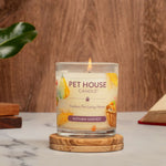 Pet House Candle labeled 'Autumn Harvest' on a wooden coaster with a floral and book background.