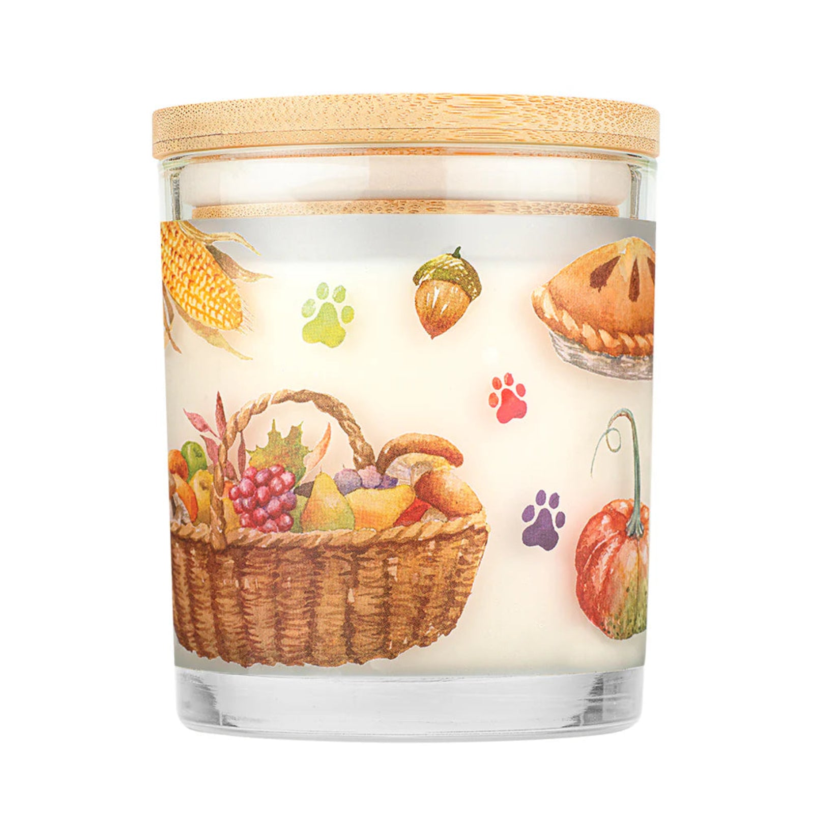 Candle with a decorative label featuring a basket of fruits, pumpkins, and paw prints on a white background.