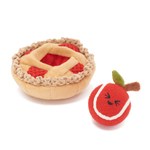 A plush dog toy set shaped like a pie and a tennis ball. The pie toy has a beige crust, red filling, and a woven lattice top.
