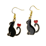 Cat-shaped earrings with red hearts on a white background