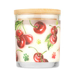 Candle with cherry design and wooden lid on a white background