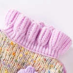 Close-up of a knitted item with pink and multicolored yarn on a white background