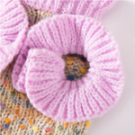 Close-up of a pink yarn ball on a textured surface